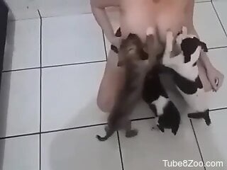 Busty woman lets puppies suck on her big nipples